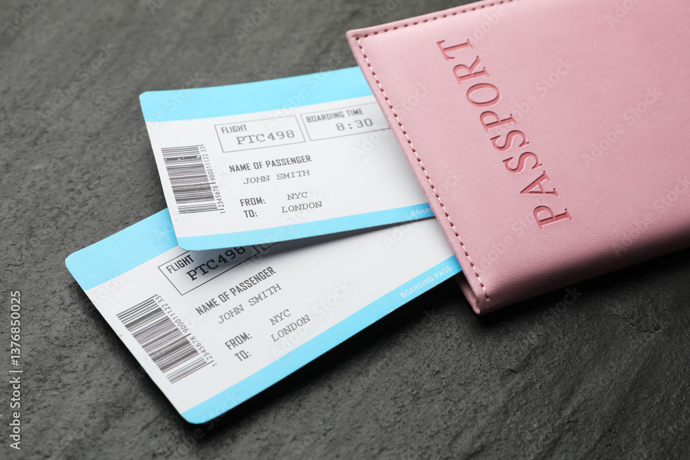 Travel agency. Flight tickets and passport on dark textured table, closeup Travel agency. Flight tickets and passport on dark textured table, closeup