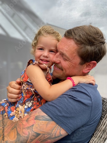 Uncle and niece sharing a joyful embrace outdoors