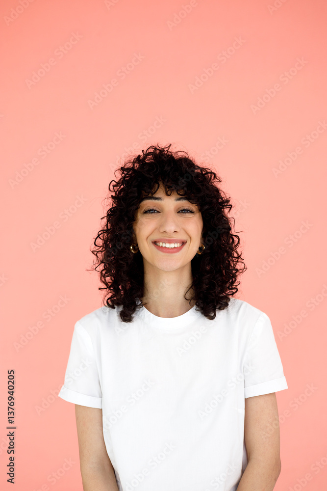 portrait of a woman smiling on a pink background portrait of a woman smiling on a pink background