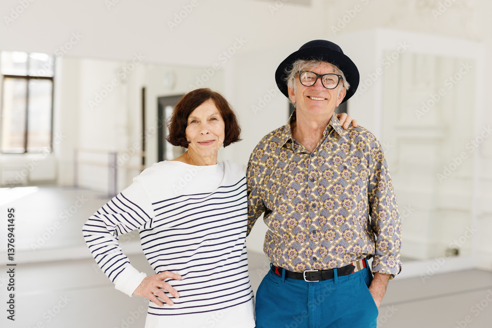 Retired couple smiling and posing for photo at dance school Retired couple smiling and posing for photo at dance school
