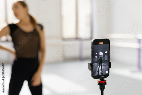 Wallpaper Mural Close-up of smartphone recording video of woman dancing in ballroom Torontodigital.ca