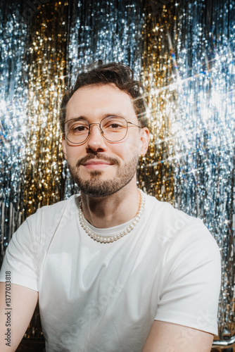 Portrait of a cheerful guy with glasses and a smile at a party