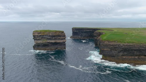 Aerial view of stunning Downpatrick Head coastal landmark with iconic Dun Briste sea stack. Dramatic cliffs and waves. Raw beauty of Ireland's west coast. Wild Atlantic Way Signature Discovery Point.