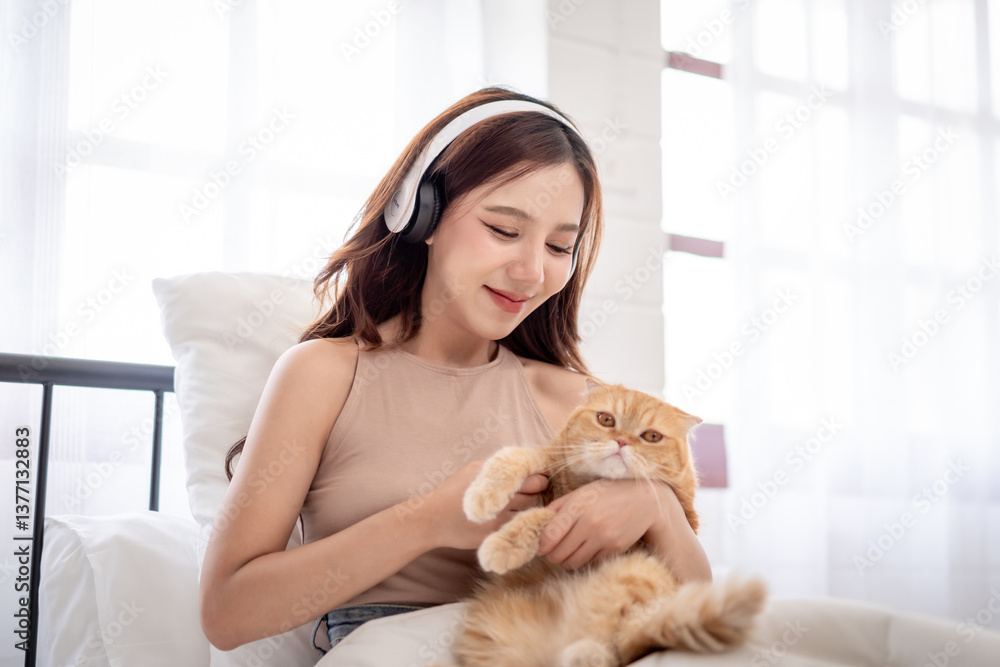 Asian young woman play with little cat with happiness in bedroom at home. Asian young woman play with little cat with happiness in bedroom at home.