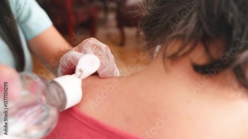Cleaning and scanning of back muscles to begin dry needling treatment, use of gloves in physical rehabilitation procedure