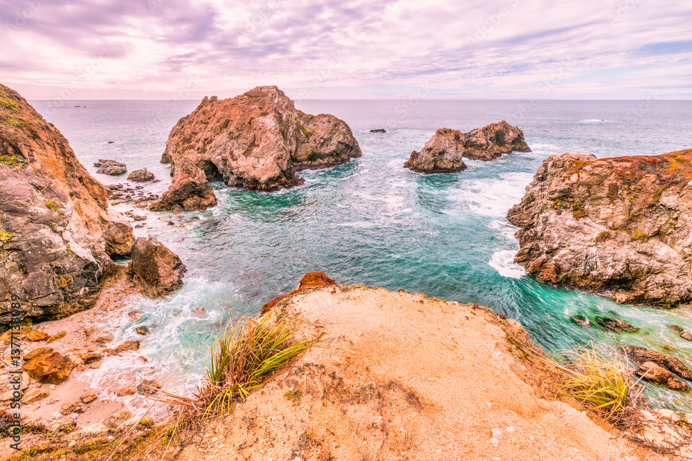 Stunning coastal landscape along California's Highway 1, featuring rugged rocky formations, and the vast blue ocean. A breathtaking natural scene showcasing the raw beauty of the Pacific coastline Stunning coastal landscape along California's Highway 1, featuring rugged rocky formations, and the vast blue ocean. A breathtaking natural scene showcasing the raw beauty of the Pacific coastline