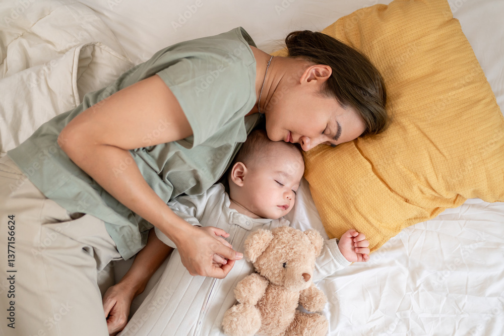 A single Asian mother lovingly cares for and raises her baby boy at home. A single Asian mother lovingly cares for and raises her baby boy at home.