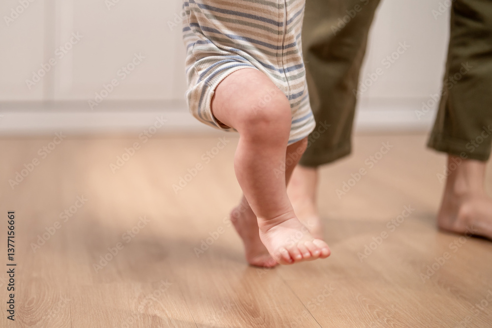 Close up of a baby's tiny feet stepping on the floor learns to walk. Close up of a baby's tiny feet stepping on the floor learns to walk.