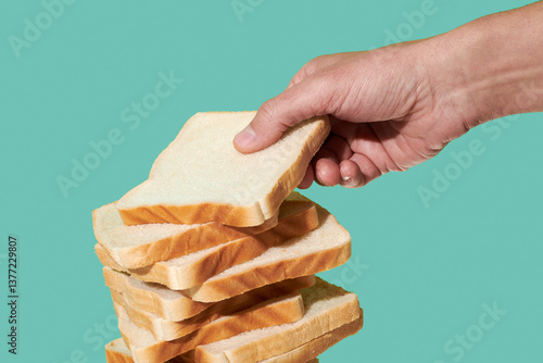 man takes a slice of sandwich bread