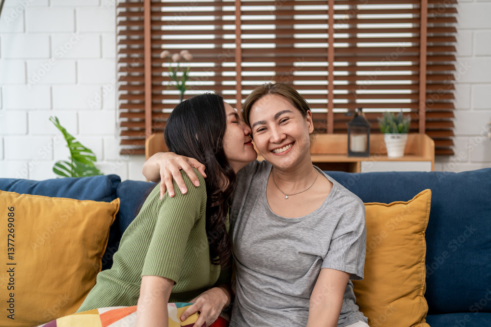 Asian young woman resting on lap of her girlfriend in living room at home.
Asian young woman resting on lap of her girlfriend in living room at home.