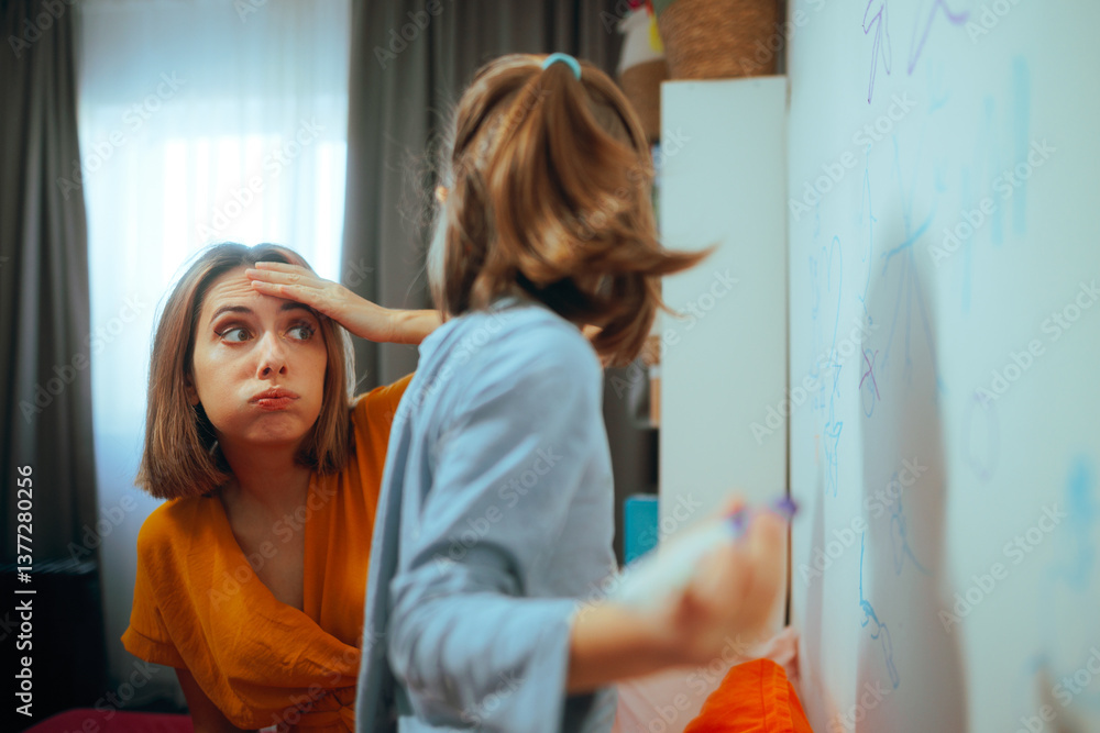 Fototapeta premium Worried Mom Catches Daughter Drawing on Walls in Her Room. Sad mother feeling annoyed by the bad deeds of her disobedient daughter
