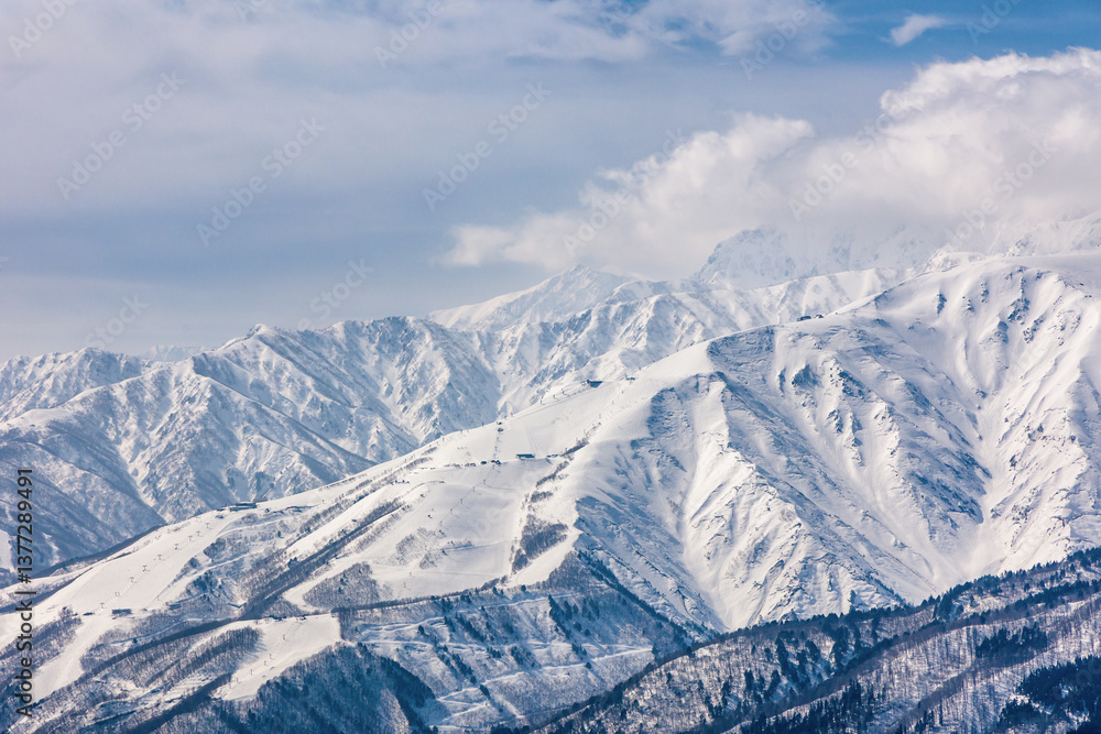 Towering snow covered mountain peaks. Alpine scenery
