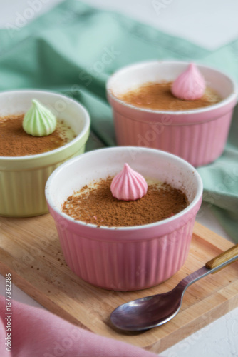 Chocolate dessert in colored cups on a wooden stand.