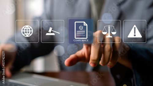 Compliance in business concept. Laws concept. Enforce laws, regulations and standards, comply with business policies, Businessman touching compliance icon on virtual screen.