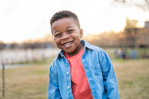 Portrait of happy african american child smiling outdoors in a park