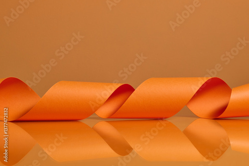 Vibrant Orange Ribbon Twisting Against Matching Background