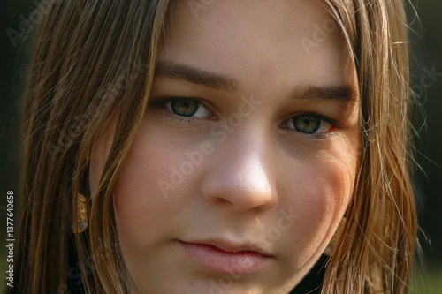 Close-up portrait of a teenage girl outdoor. Teenage girl in park. Cute teen girl outdoors.