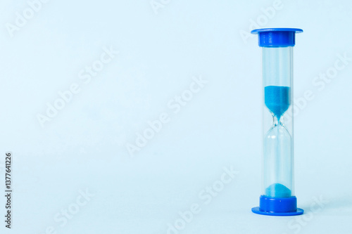 hourglass on the table, sand clock as time passing concept for business deadline, copy space