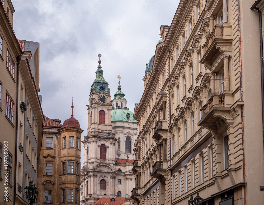 St. Nicholas Church in Prague’s Lesser Town, featuring stunning baroque architecture, green domes, and clock tower framed by surrounding historic buildings. St. Nicholas Church in Prague’s Lesser Town, featuring stunning baroque architecture, green domes, and clock tower framed by surrounding historic buildings.