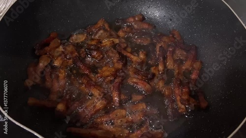 Overcooked Pork bacon Cubes Frying in Pan with Smoking Oil