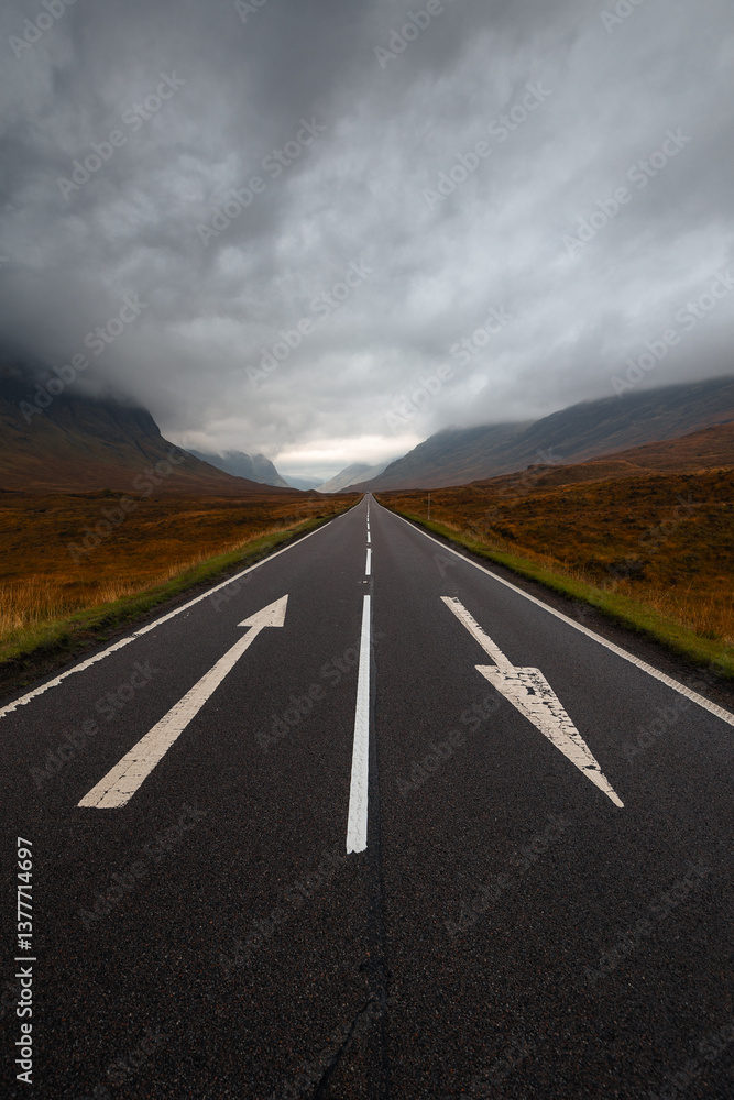 Dramatic peaks and misty valleys define Glen Coe, Scotland’s iconic Highland landscape. Golden light dances on rugged slopes, creating a scene of wild, untamed beauty.