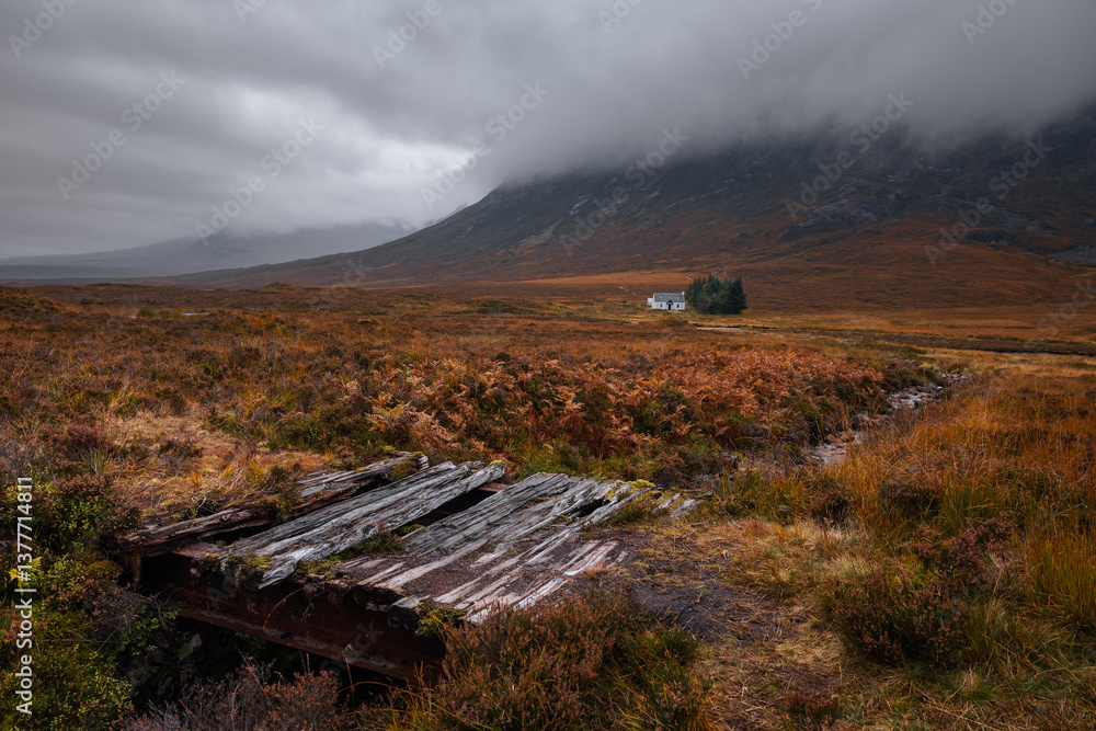 Dramatic peaks and misty valleys define Glen Coe, Scotland’s iconic Highland landscape. Golden light dances on rugged slopes, creating a scene of wild, untamed beauty.