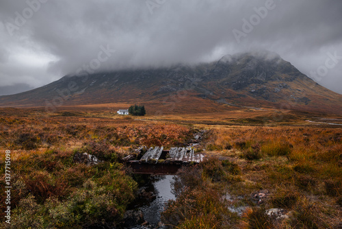 Obraz na płótnie Dramatic peaks and misty valleys define Glen Coe, Scotland’s iconic Highland landscape. Golden light dances on rugged slopes, creating a scene of wild, untamed beauty. w salonie