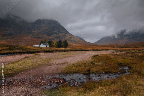 Obraz na płótnie Dramatic peaks and misty valleys define Glen Coe, Scotland’s iconic Highland landscape. Golden light dances on rugged slopes, creating a scene of wild, untamed beauty. w salonie