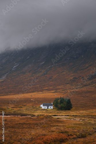 Obraz na płótnie Dramatic peaks and misty valleys define Glen Coe, Scotland’s iconic Highland landscape. Golden light dances on rugged slopes, creating a scene of wild, untamed beauty. w salonie