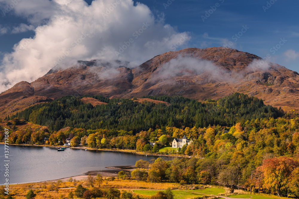 Golden autumn hues surround the Glenfinnan Viaduct, as misty hills and serene lochs create a magical Highland scene. A perfect blend of history and nature in Scotland’s fall splendor.