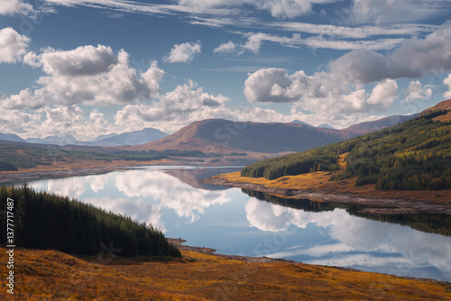 Obraz na płótnie Golden light bathes Corpach’s shores, where the iconic shipwreck rests against Ben Nevis’ misty peaks. A serene autumn morning unfolds over Scotland’s rugged beauty. w salonie
