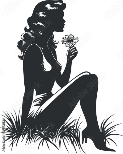 Silhouette of a woman sitting in grass holding a flower, illustrating elegance and femininity.