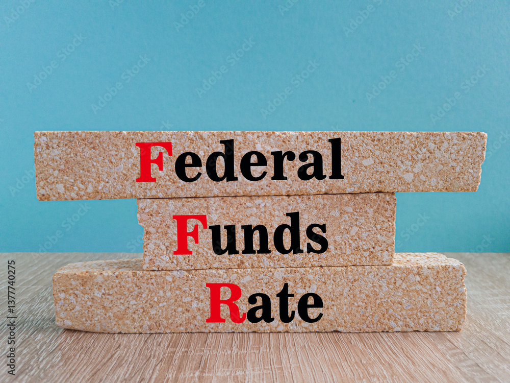 FEDERAL FUNDS RATE symbol. Brick blocks with words FEDERAL FUNDS RATE on wooden table. Blue background. Business concept.