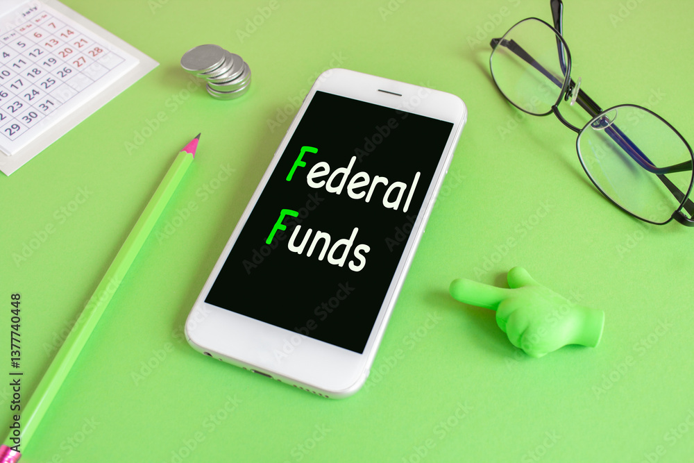 FEDERAL FUNDS symbol. Concept words FEDERAL FUNDS written on the mobile phone screen. Beautiful green background. Glasses, coins. Business concept.