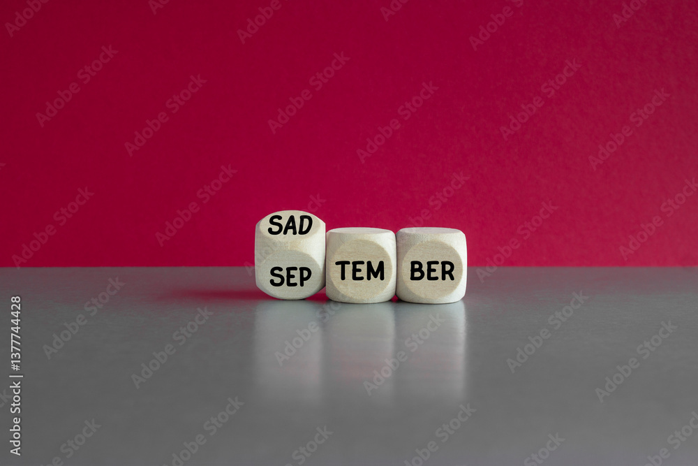 Concept words September is Sadtember on wooden cubes. Beautiful red background, gray table. Business September is Sadtember concept.