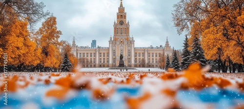 Snowy Autumn Day on Campus Majestic University Building amid Golden Leaves and First Snowfall