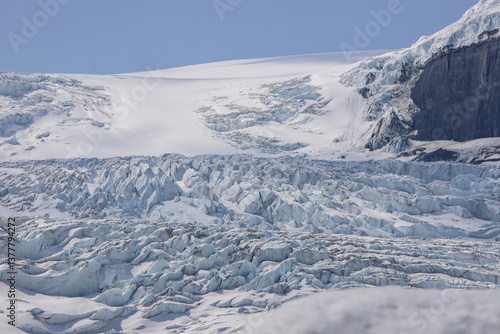 Expansive view of Columbia Icefield glacier showing pale blue ice ridges and snow-covered plateau in Banff National Park, Alberta, Canada