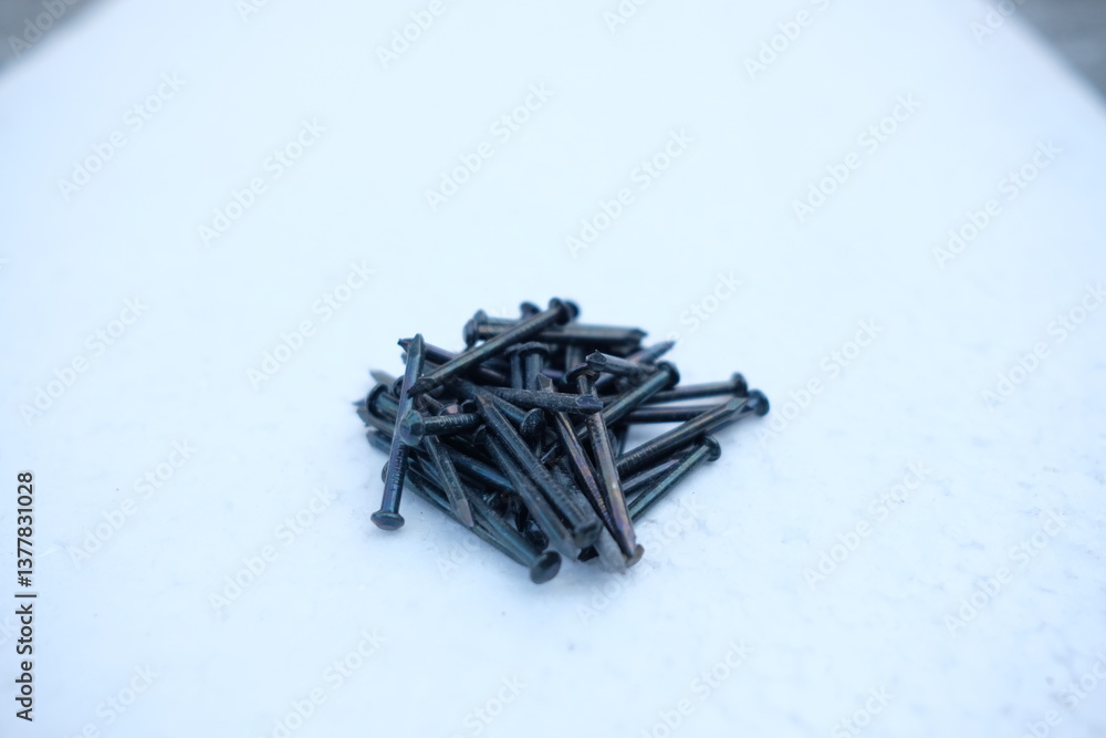 Photo of a pile of nails with a white background Photo of a pile of nails with a white background