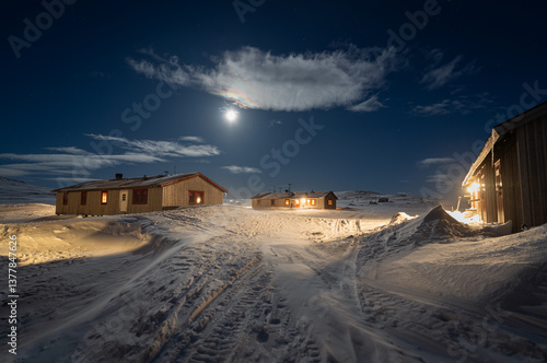 Obraz na płótnie Full moon over Helags Mountain station in Jämtland, Sweden, during a cold and windy night in March. w salonie