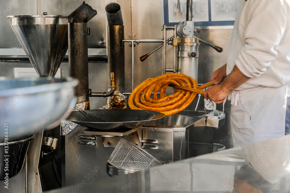 Man preparing tasty traditional churros in Seville, Spain