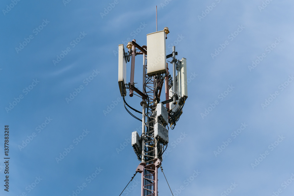 Close-up of the top of a tall mast with mobile cellular antennas Close-up of the top of a tall mast with mobile cellular antennas