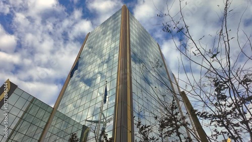 Glass facade of OLAF headquarters building in Brussels under cloudy sky