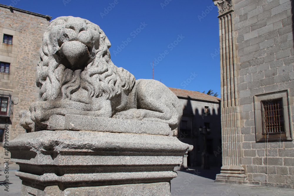 sculpted lion in front of the cathedral in avila in spain