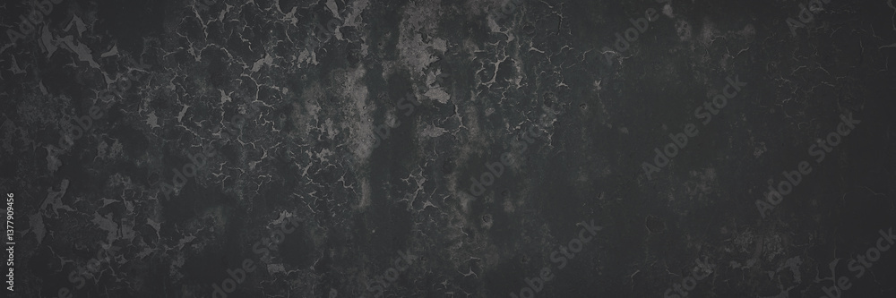 Dark wide panoramic background. Peeling paint on a concrete wall. Faded dark texture of old cracked flaking paint. Weathered rough painted surface with patterns of cracks. Shaded background for design