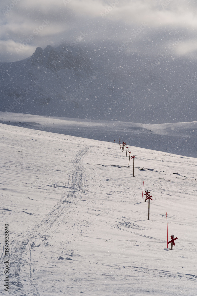 Snowfall at a marked trail for cross-country skiing toward mountain Templet, in the Sylarna mountain range