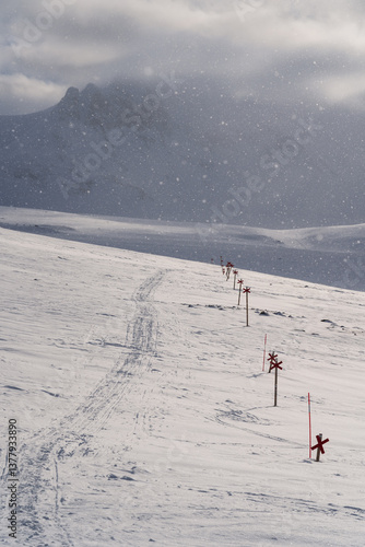 Snowfall at a marked trail for cross-country skiing toward mountain Templet, in the Sylarna mountain range