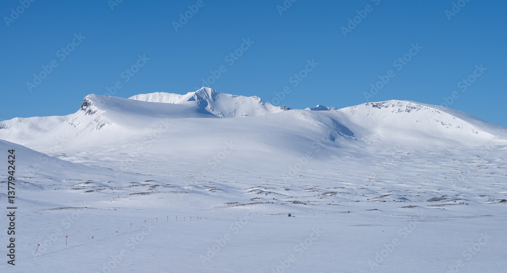 Cross-country skiing trail and the Sylarna mountain range on a beautiful day in winter. Sweden.