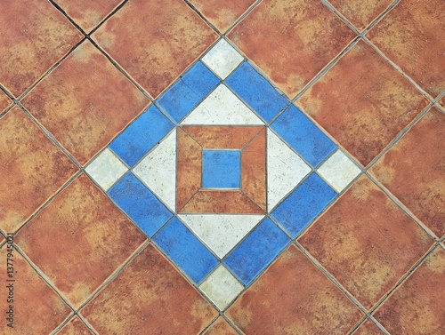 Traditional Mediterranean Terracotta Tile Floor with a Central Diamond-Shaped Medallion Featuring Blue, White, and Brown Geometric Patterns