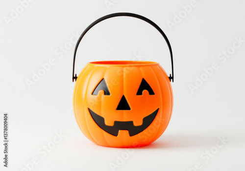 Cute plastic pumpkin halloween candy bucket with smiling face isolated on white background