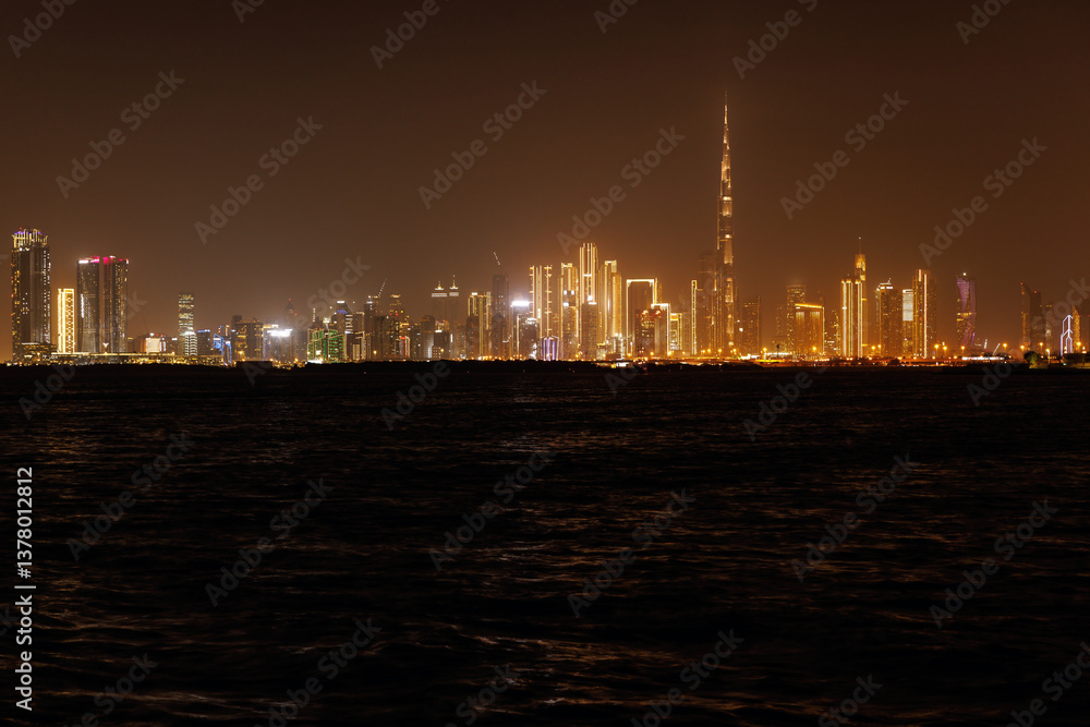 Fototapeta premium Panoramic view of a big futuristic Dubai city by night, United Arab Emirates